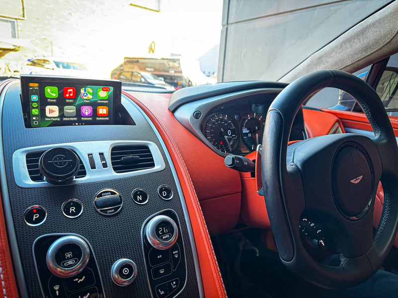 Aston Martin central console with OEM look after CarPlay upgrade.