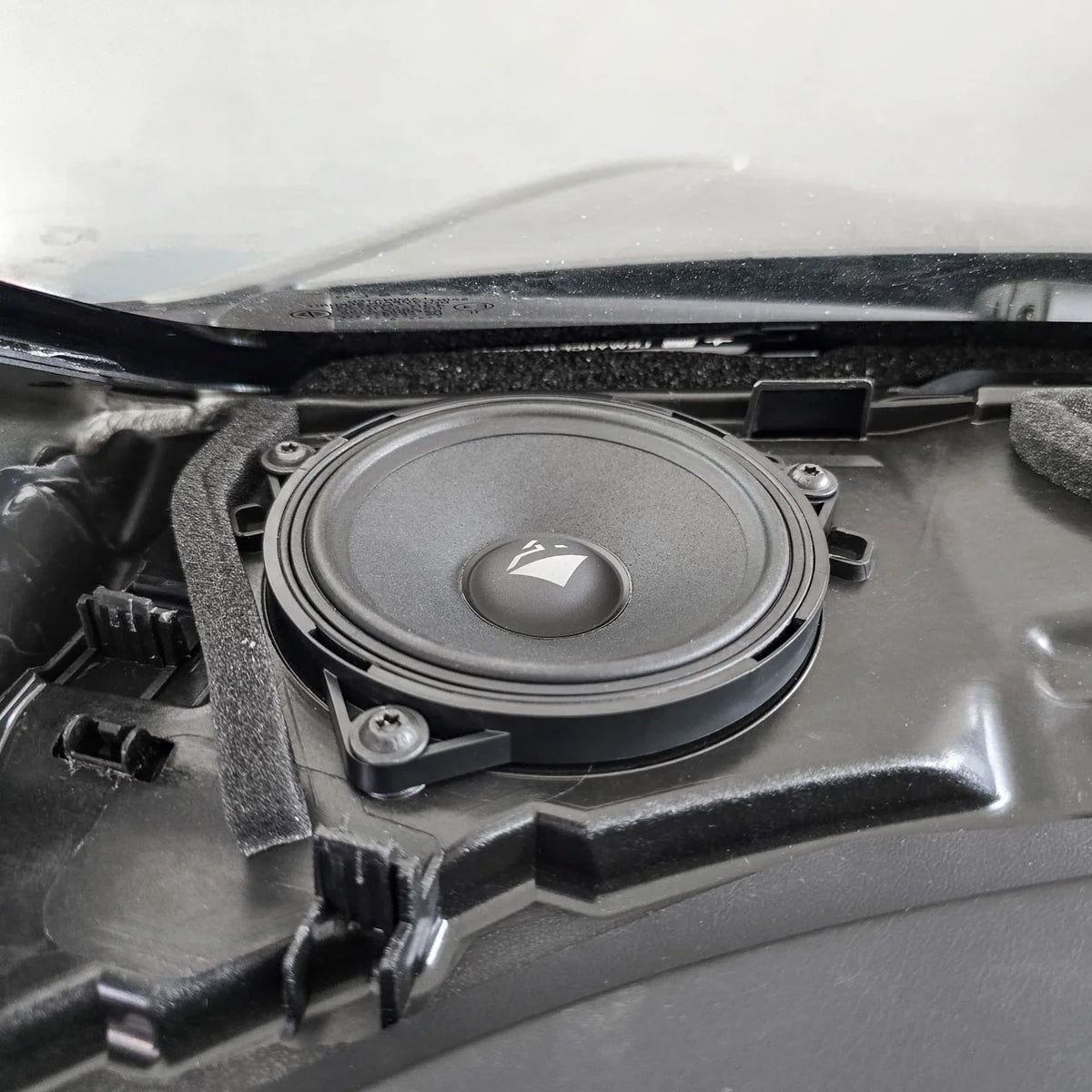 HELIX Ci3 dashboard midrange shown installed in the Tesla Model Y front speaker upgrade